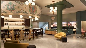A modern bar with a green pillar and a mural on the wall